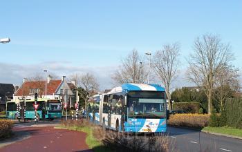 Modern office space rental at Strijkviertel 63 in De Meern, with city buses passing by in the foreground.