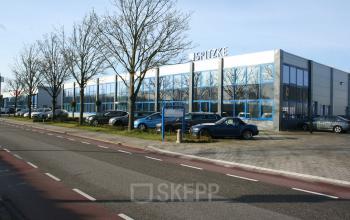 Modern exterior view of office space rental at Strijkviertel 63, De Meern, with large windows and parked cars outside.