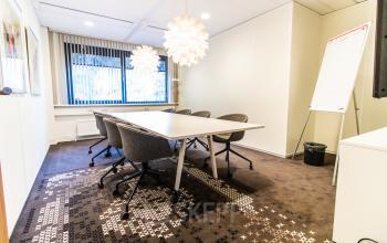 Bright office space rental at Marshalllaan 2, Delft, featuring a modern conference room with stylish lighting and seating. Ideal for businesses seeking an office to rent.
