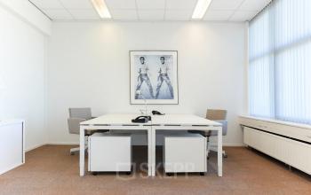 Bright office space with modern white desks and chairs at Marshalllaan 2, Delft. Ideal for rent office space with effective lighting and minimal decor.