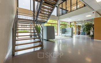 Spacious office interior at Delftechpark 9 in Delft, available for rent. Features modern design with large windows and seating areas, perfect for office space rental.