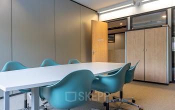 Furnished office space at Delftechpark 9, Delft, featuring a meeting table with chairs, ideal for those looking to rent office space.
