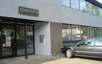 Exterior view of Eemstaete office building at Eemweg 1-9, Den Bosch, showing the entrance with a clear label, ideal for those looking to rent office space.