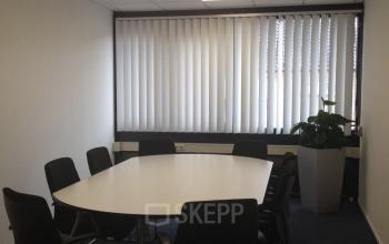 Modern office space rental at Eemweg 1-9, Den Bosch, featuring a well-lit conference room with a large table and chairs.