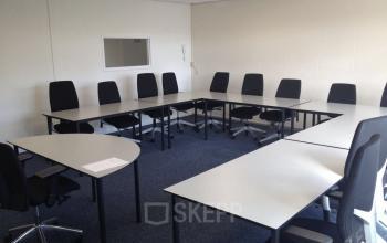 Modern conference room ready for a business meeting at office space rental on Eemweg 1-9, Den Bosch, with a large table and chairs.