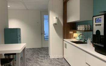 A well-equipped office space rental at Stationsplein 91, Den Bosch, featuring a tidy kitchenette and modern amenities.
