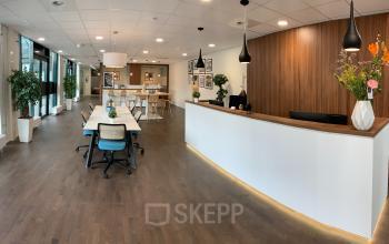 Modern office space with a sleek reception desk at Stationsplein 91, Den Bosch, ideal for those looking to rent office space.