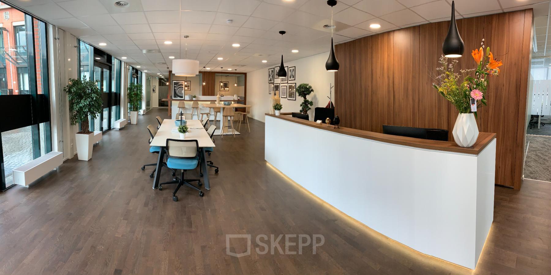 Modern office space with a sleek reception desk at Stationsplein 91, Den Bosch, ideal for those looking to rent office space.