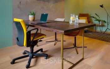 Office space at Bruistensingel 400 in Den Bosch featuring a stylish table with chairs, a laptop, and plants, ideal for rent office space.