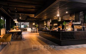 Furnished office space rental at Bruistensingel 400, Den Bosch, featuring a stylish interior with a workspace and a cozy seating area.