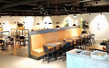 Modern workspace at Utopialaan 22, Den Bosch, featuring contemporary seating with industrial-style lighting, perfect for office space rental.