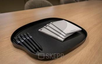 Close-up view of notepads and pens on a desk, offering a glimpse of an office workspace setting at Pettelaarpark 110, ideal for office space rental in Den Bosch.