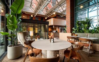Inviting office space rental with stylish furniture at Hambakenwetering 5, Den Bosch, featuring modern seating and lush plants, ideal for collaborative work.