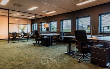 Furnished office space for rent at Reitschweg 1, Den Bosch, featuring desks, chairs, and ample natural light.