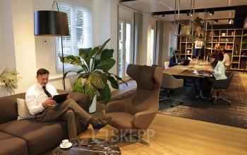 Contemporary office space rental at Koninginnegracht 19 in The Hague Center with professionals engaged in business tasks.