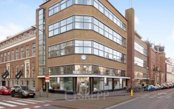 Exterior view of an office building for rent at Zeestraat 100, The Hague Center, showing a modern facade with large windows.