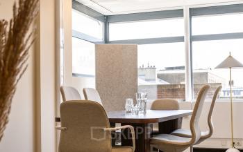 Furnished office space at Zeestraat 100, The Hague Center, featuring a conference table and chairs, available for office space rental.