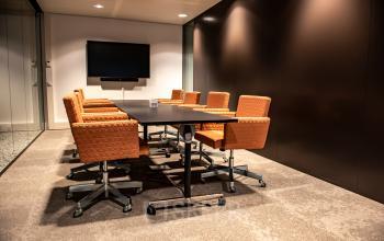 Office to rent at Anna van Buerenplein 41, The Hague Center featuring a furnished conference room with a sleek table and comfortable chairs, ideal for meetings.