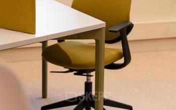 Comfortable workspaces featuring modern chairs and a collaborative desk setup, perfect for office space rental at Zeestraat 70, The Hague Center.