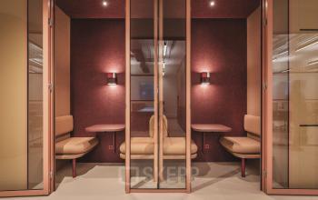 Small, stylish office space with built-in seating and soft lighting, perfect for focused work sessions at Zeestraat 70, The Hague Center. Ideal for office space rental needs.