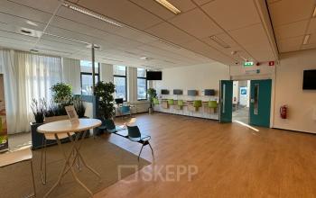 Bright, modern office interior at Platinaweg 10, The Hague Escamp, featuring open workspaces with stylish chairs and tables, ideal for office space rental.