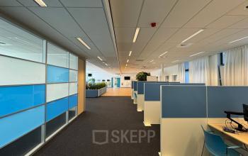 Open floorplan office interior at Platinaweg 10, The Hague Escamp, featuring modern cubicles, sleek design, and ample natural light. Ideal for those seeking an office space rental with contemporary workspaces.