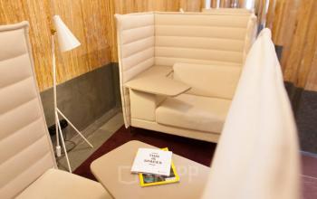 Elegant hallway with modern high-back seating in a Zuid Hollandlaan 7 office to rent, located in The Hague Haagse Hout.