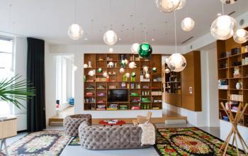 Modern office space rental at Zuid Hollandlaan 7, The Hague Haagse Hout, featuring a stylish interior with unique lighting fixtures and a cozy seating area.