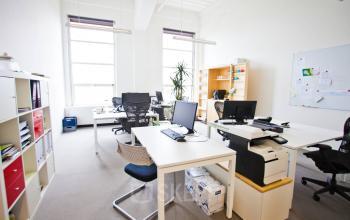 Bright and inviting office space rental at Zuid Hollandlaan 7, The Hague Haagse Hout, equipped with desks, chairs, and storage units.