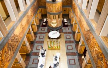 Spacious and well-lit atrium in an office space rental at Zuid Hollandlaan 7, The Hague Haagse Hout, with people engaged in business activities.