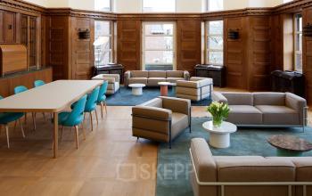 Elegant office lounge area with contemporary furniture offering a relaxed atmosphere for an office space rental at Zuid Hollandlaan 7, The Hague Haagse Hout.