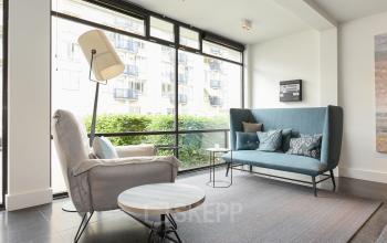 Modern furnished office lounge area at Bezuidenhoutseweg 161, The Hague Haagse Hout, offering comfortable seating and views, ideal for office space rental.