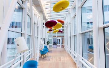 Bright office space rental at Jan Pietersz. Coenstraat 7, The Hague Haagse Hout with colorful hanging lights and modern chairs.