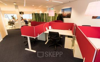 Modern office space rental at Jan Pietersz. Coenstraat 7, The Hague Haagse Hout with red partitions and ergonomic chairs.