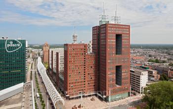 Exterior view of Prinses Margrietplantsoen 25 office building in The Hague Haagse Hout, showcasing modern architecture and panoramic cityscape. Ideal for office space rental in a bustling business area.