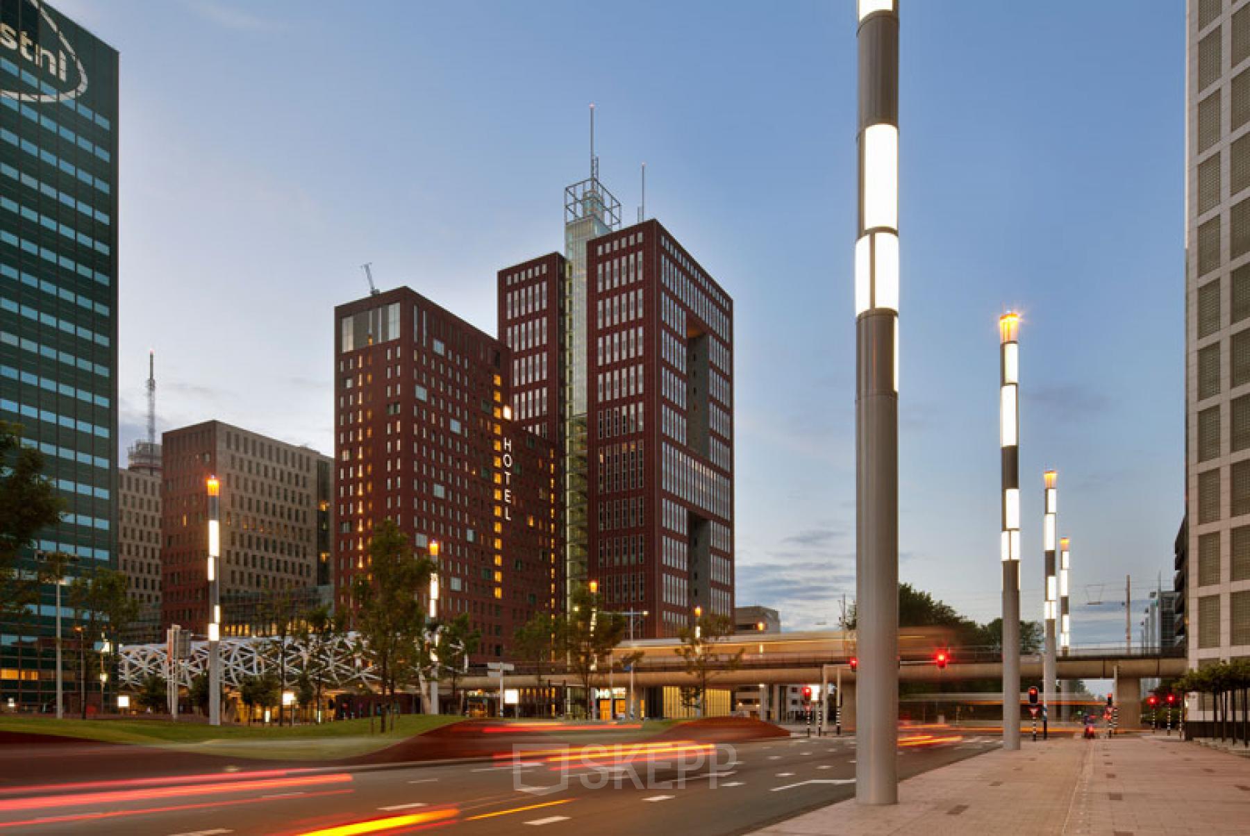 A modern exterior view of Prinses Margrietplantsoen 25 in The Hague Haagse Hout, featuring high-rise office buildings with striking architecture, ideal for office space rental.