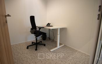 Minimalist office space at Schenkkade 50, The Hague Haagse Hout, featuring a desk and chair, ideal for rent office space seekers.