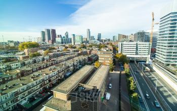 View of The Hague from Schenkkade 50, showcasing surrounding buildings and skyline. Ideal location for office space rental.