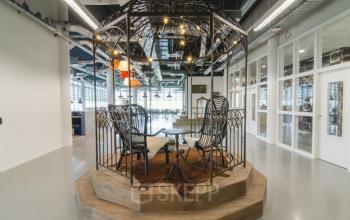 Stylish, modern office space for rent at Oude Middenweg 3-19, The Hague Leidschenveen-ypenburg, featuring unique, open workspace with metal gazebo structure and contemporary seating.