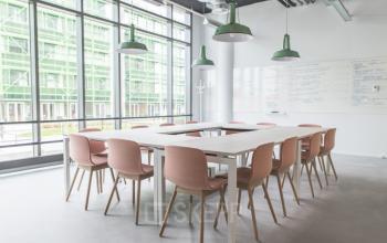 Modern conference room at Oude Middenweg 3-19, The Hague Leidschenveen-ypenburg, featuring spacious tables, chairs, whiteboards, and large windows with natural light.
