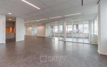 Spacious, well-lit office space rental at Oude Middenweg 3-19 in The Hague featuring large windows and a flexible open floor plan.