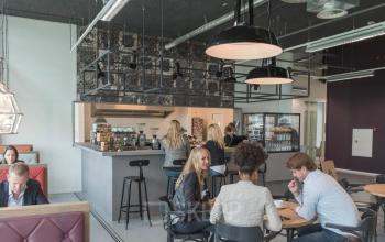Office pantry at Oude Middenweg 3-19, The Hague Leidschenveen-ypenburg, featuring modern seating with people working and discussing business.