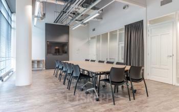 Modern office space rental at Oude Middenweg 3-19, The Hague, featuring a well-lit conference room with a large table and comfortable seating.