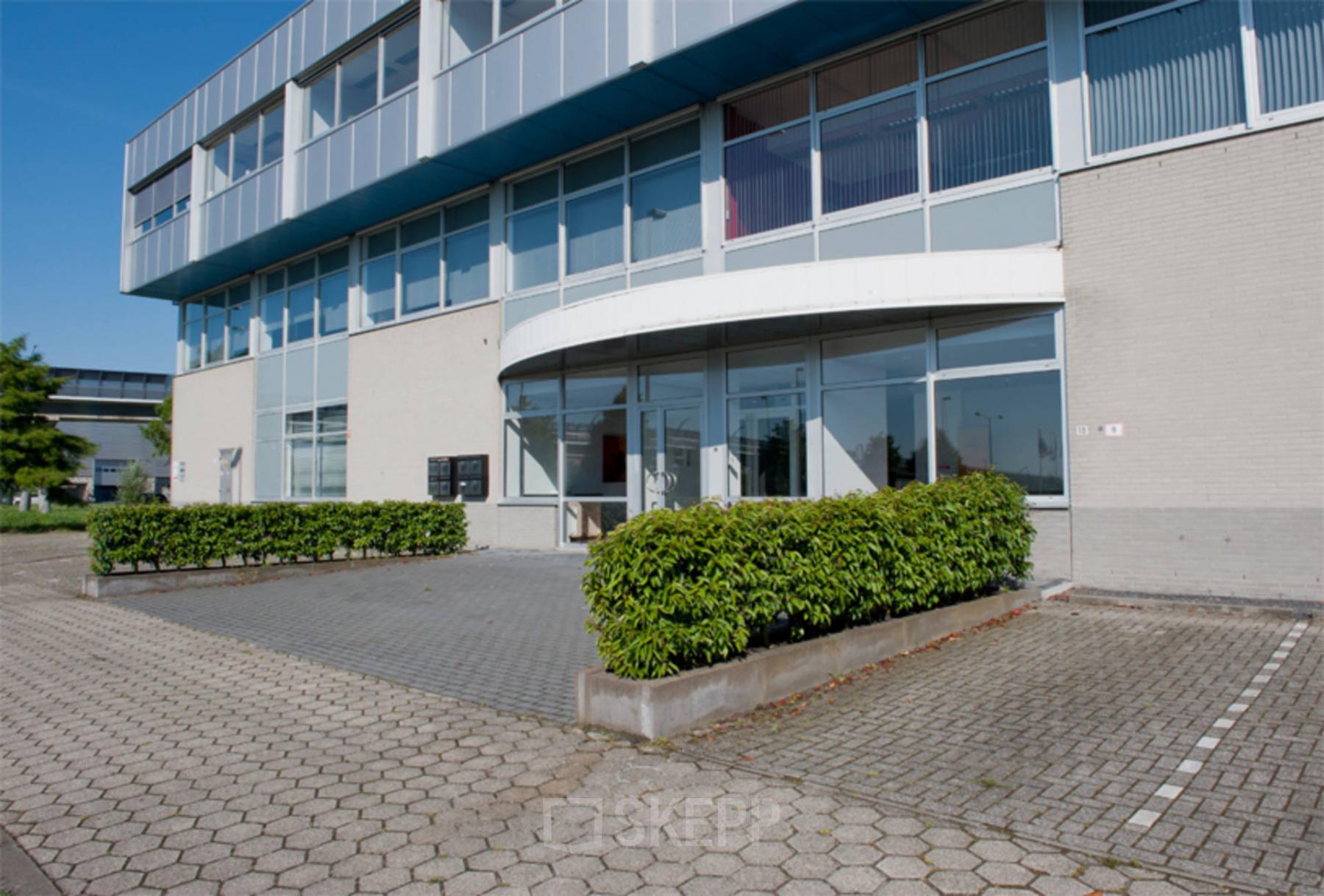 Exterior view of office space rental at De Rijn 18-22 in The Hague Leidschenveen-Ypenburg, featuring a modern building facade with clear glass windows.