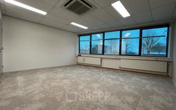 Unfurnished office space with large window and carpeted floor at Oder 20, The Hague Leidschenveen-ypenburg, perfect for office space rental.