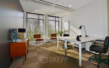 Elegantly furnished office space available for rent at President Kennedylaan 19, The Hague, with modern desks and comfortable seating.