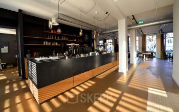 Modern office space rental at President Kennedylaan 19 in The Hague with a stylish coffee bar and comfortable seating area