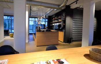 Modern and inviting office space rental at President Kennedylaan 19 in The Hague, with a stylish pantry and seating area.