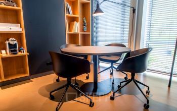 Elegant office meeting space available for office space rental at President Kennedylaan 19, The Hague, with modern chairs and ample natural light.
