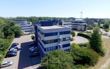 Exterior view of an office building at Keulenstraat 15, Deventer surrounded by greenery, ideal for office space rental.